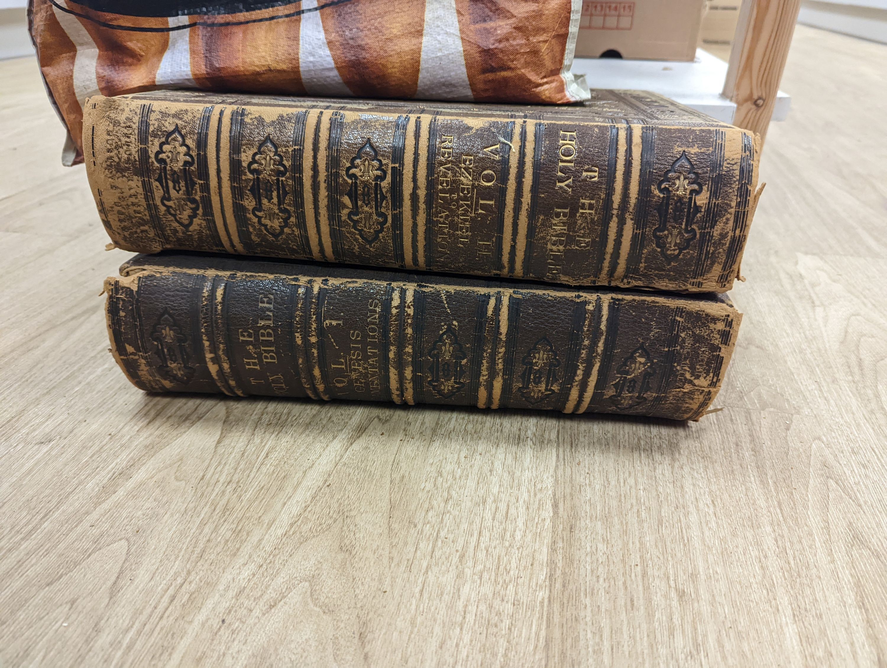 A group of leather bound books and 2 bibles.